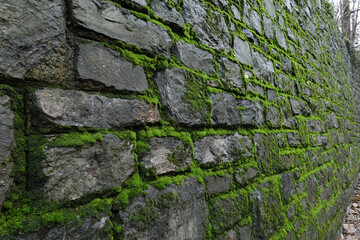 Rough Stone Wall Texture Background, Stone wall with moss, textured surface