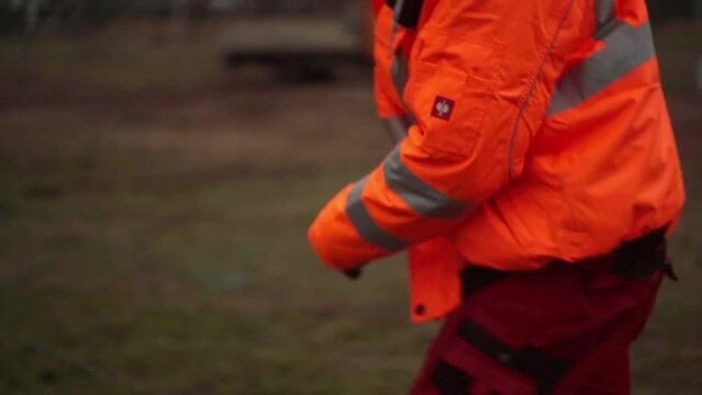 Construction worker pulling s steel cable.