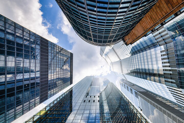 Looking directly up at the skyline of the financial district in central London, modern architecture as a background