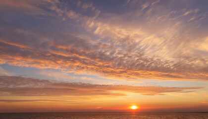 Real majestic sunrise sundown sky background with gentle colorful clouds.