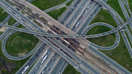 Aerial highway junction bustling with traffic, urban connectivity showcased Drone shot seamless flow, infrastructure strength. Efficient transportation, arterial roadways converge, pulse of city life.