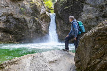 Germany, Bavaria, Allgaeu, male hiker in front of Buchenegger Wasserfalle, waterfall