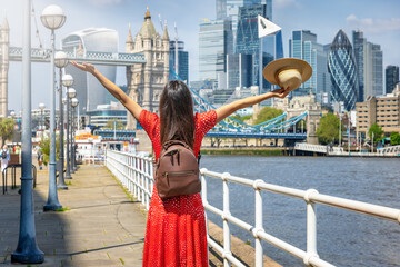 City traveler concept with a happy tourist woman looking at the skyline of London, England, during...