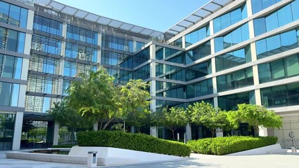 Modern glass office building exterior with reflection in the windows. Bottom up view. Wide angle shot. High quality 4k footage