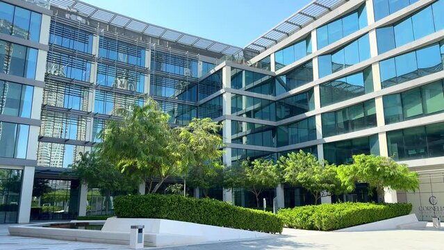 Modern glass office building exterior with reflection in the windows. Bottom up view. Wide angle shot. High quality 4k footage