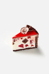 Slice of chocolate sponge cake with creamy cherry filling