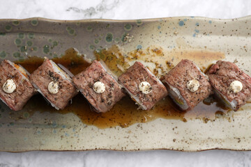 Wagyu sushi on a marble table background