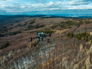 Aerial view of a drone moderning over forest, monitoring and analyzing in forestry management. Dron...