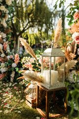 Wedding. Wedding ceremony. Arch. Arch decorated with pink and white flowers in the wedding ceremony area, candlestick