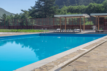 A heated pool high in the mountains. Relaxing by the water in the fresh air. Sun loungers for...