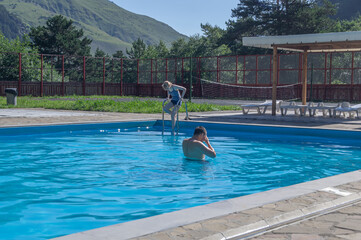 A heated pool high in the mountains. Relaxing by the water in the fresh air. Sun loungers for...