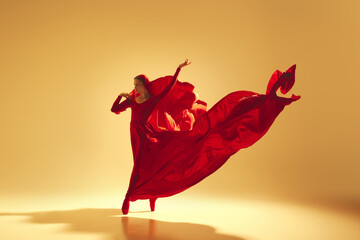 Lyrics of movement, Elegant woman, female dancer in red flowing dress with face covered dancing...