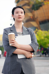 Confident Businesswoman with Tablet and Coffee Outdoors
