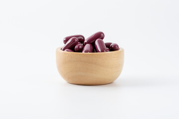 purple vitamin pills on white background	
