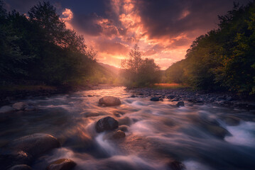 Magic sunrise over fast flowing mountain river