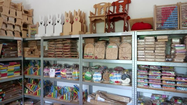 Wooden games wrapped, stored on shelf in small game factory, ready for shipping.