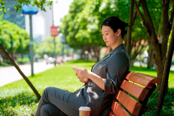 Fototapeta premium Serene Urban Oasis: Woman Relaxing on Park Bench