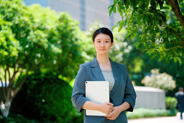Fototapeta premium Confident Businesswoman holding Tablet in Urban Setting