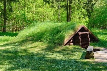 Reconstructed dugouts and shelters for soldiers from World War II in the forest. Setting up partisan camps.