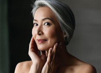 Mid age adult asian woman standing in bathroom after shower