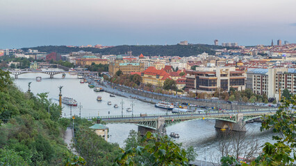 Fototapeta premium Aerial evening view of the Vltava River and illuminated bridges day to night timelapse, Prague