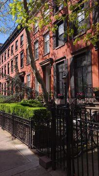 Row of 19th century townhouses in Chelsea Historic District. Spring walk in Manhattan, New York City