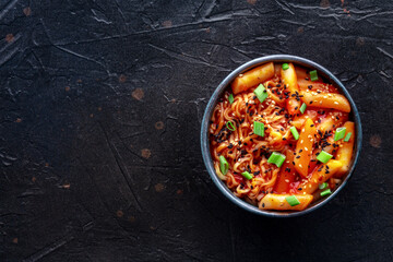 Rabokki, tteokbokki or topokki with ramen, Korean street food, spicy rice cakes in red pepper gochujang sauce, overhead flat lay shot