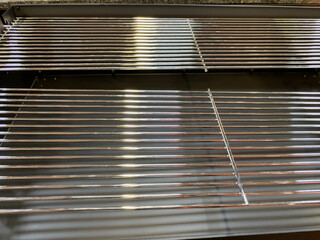 A grill with a lot of metal bars and a shiny surface