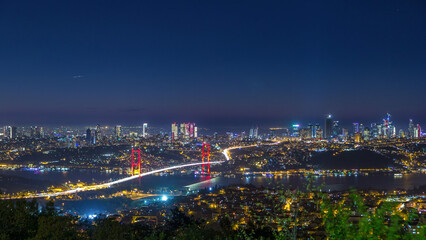 Istanbul city skyline cityscape night time lapse view of bosphorus bridge and financial business center