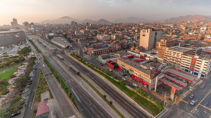 Fototapeta premium Aerial view of Via Expresa highway and metropolitan bus with traffic during sunset timelapse. Lima, Peru