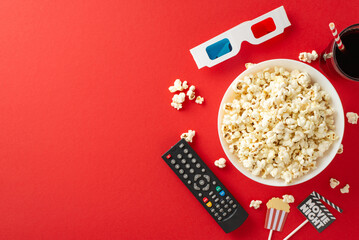 Enjoy premieres on TV app at home. Top view of popcorn, soda, 3D glasses, remote control, and...