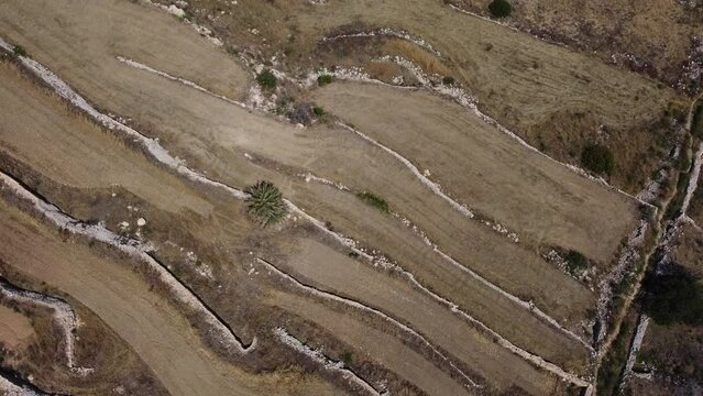Agricultural fields, terraced land, malta,Aerial view. Revealing Mistra bay, st pauls island, Qawra and Buggiba in the distance, Mediterranean Sea. High quality 4k footage