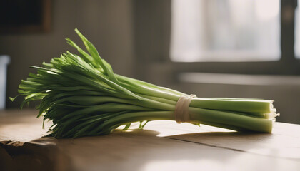 Bunch of freshly picked leeks standing on wooden table.
