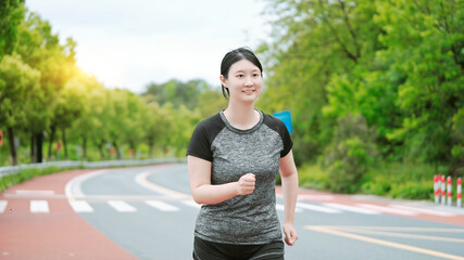 Active Woman Enjoying a Sunny Run in the Park