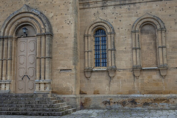 Fototapeta premium Bullet marks are visible on the walls of the ancient church. The damaged church during the war. The Armenian Orthodox Church in Derbent. The walls of the ancient church are made of hewn stones.