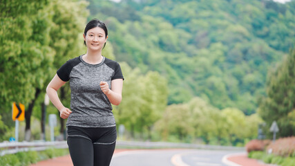 Active Woman Enjoying a Scenic Jog in Nature