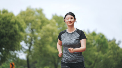 Active Woman Enjoying a Healthy Morning Jog in Park