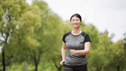 Active Young Woman Enjoying a Healthy Jog in the Park