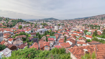 Obraz premium City panorama with cable car moving up and down from Sarajevo station to mountains, Bosnia And Herzegovina