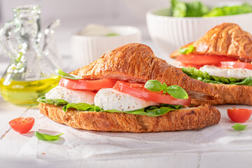 Hot and homemade french croissant with tomatoes and mozzarella