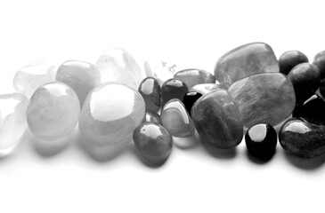 Healing chakra crystals, monochrome photo. Real semi-precious stones: rose quartz, amethyst,...