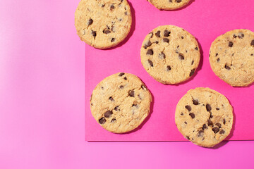 Fresh cookies with chocolate chips on a pink background. Dessert, a pastry shop.