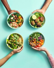 Multiethnic hands holding a diverse food plates of salads. Pastel green blue background.