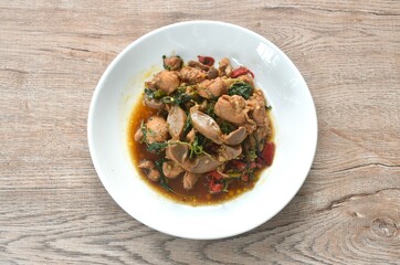 spicy chili stir-fried chicken meat and gizzard couple liver with basil leaf on plate