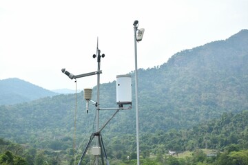 wind speed measurement using vane in mountain background with rain cloud on sky