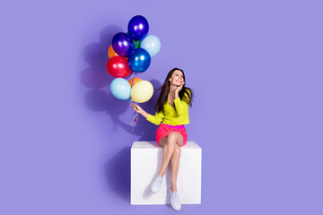 Photo of adorable cute girl dressed trendy clothes hold helium balloon look empty space isolated on purple color background