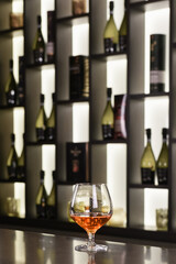 Glass of alcoholic drink on the bar counter. Production and sale of alcohol. Alcoholic beverage industry