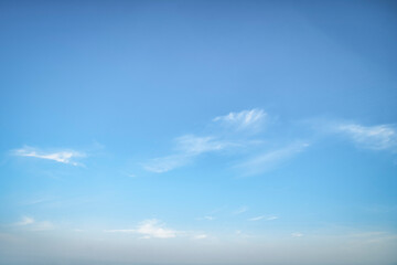 Clear blue sky. Light background with small white clouds.
