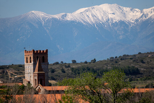 he clovher of Espira de l'Agly in front of the snow-covered Canigou

