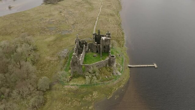 The Ruins Of Historic Kilchurn Castle And Jetty On Loch Awe, Argyll, Scotland